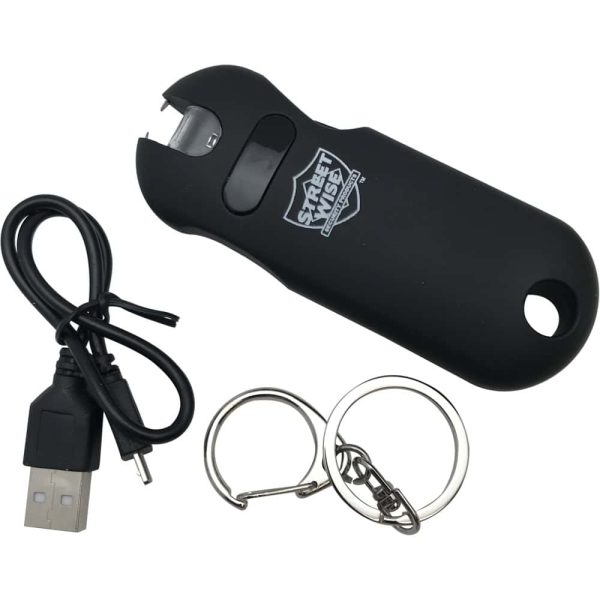 Black keychain stun gun with USB charging cable and metal rings for self-defense.