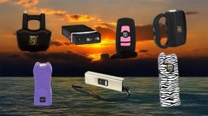 Assorted self-defense stun guns and tasers with a sunset ocean backdrop.
