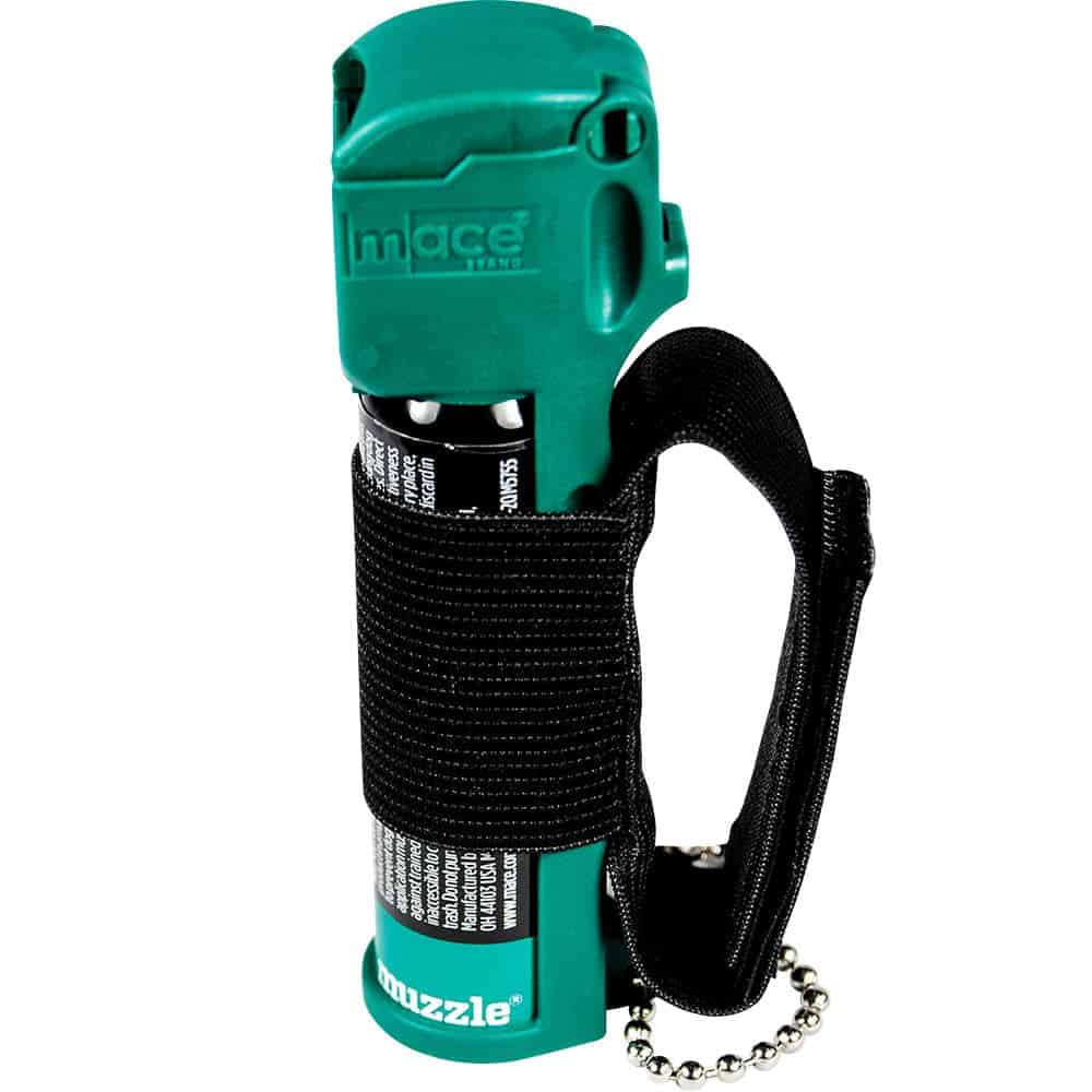 Green pepper spray with black strap and keychain for personal safety and self-defense.