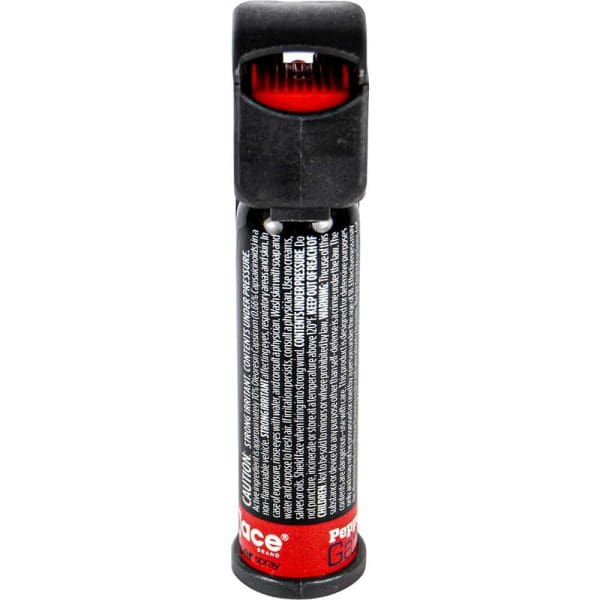 Black pepper spray canister with red safety guard, upright position, detailed text visible on the label.