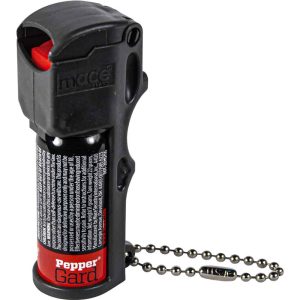 Compact pepper spray with safety cap and keychain attachment for personal protection.