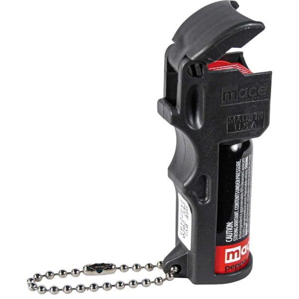Black pepper spray with flip-top and keychain, labeled Mace, designed for personal safety and self-defense.