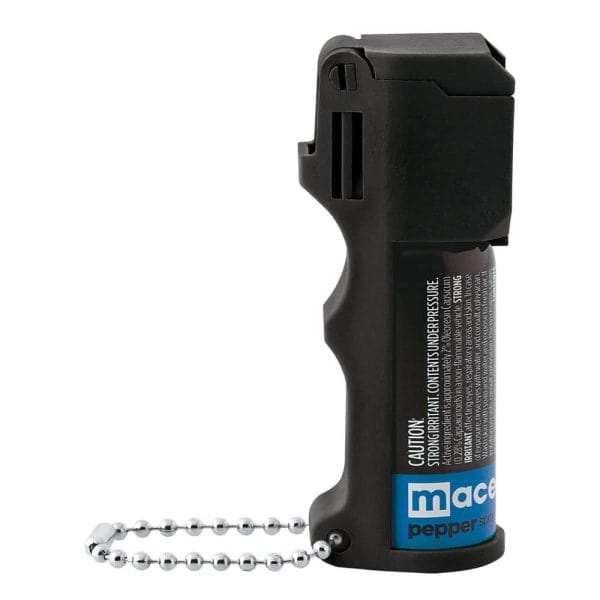Black pepper spray canister with chain for personal safety and self-defense.
