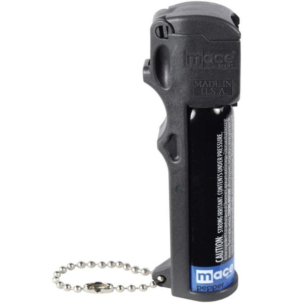 Black pepper spray canister with safety cap and keychain attachment for self-defense.