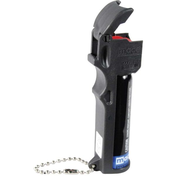Black pepper spray canister with flip-top safety cap and keychain, designed for personal security.