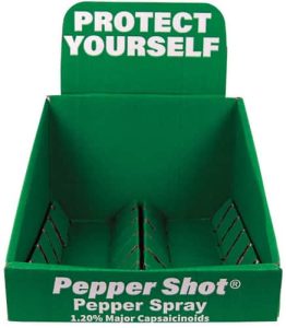 Green display box for Pepper Shot pepper spray with Protect Yourself text, featuring 1.20% major capsaicinoids.