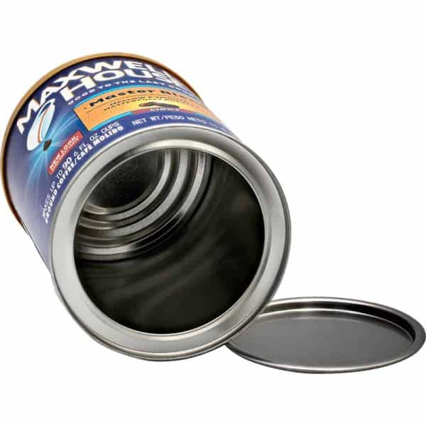 Open Maxwell House coffee can with lid beside it, showcasing inside view.
