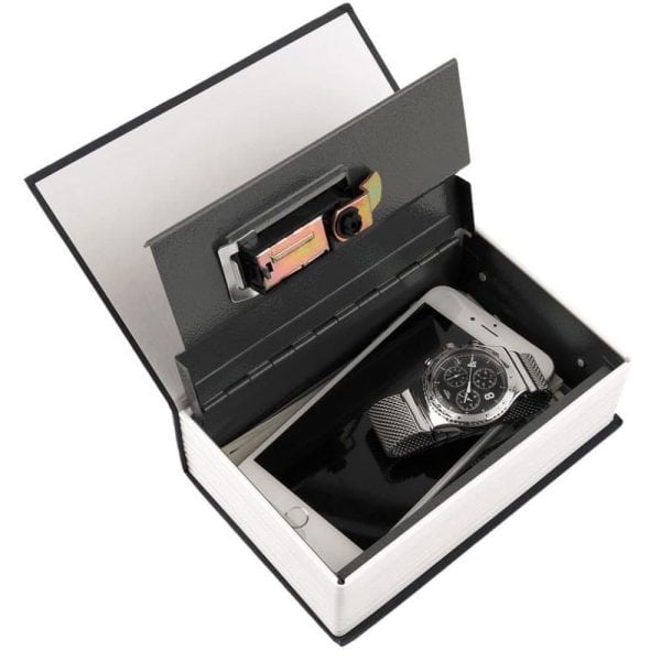 Hidden book safe storing a smartphone and watch, featuring a locked steel compartment for discreet security.