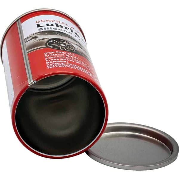 Red can of silicone lubricant lying open with lid beside it.