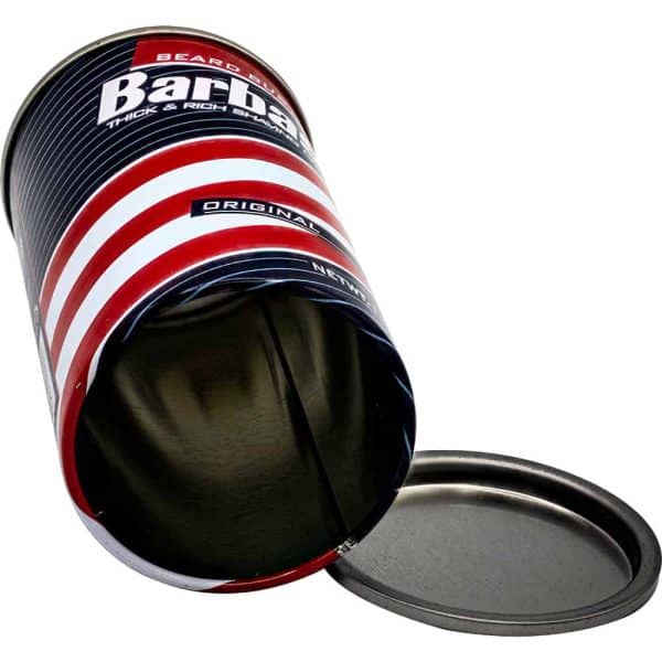 Empty can with red and white stripes, labeled Barbasol, lying on its side with the lid off.