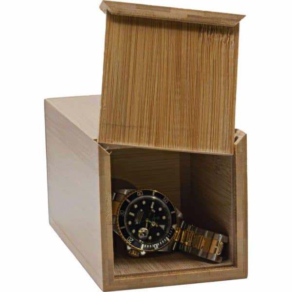 Gold watch in an open wooden box, showcasing luxury and elegance.