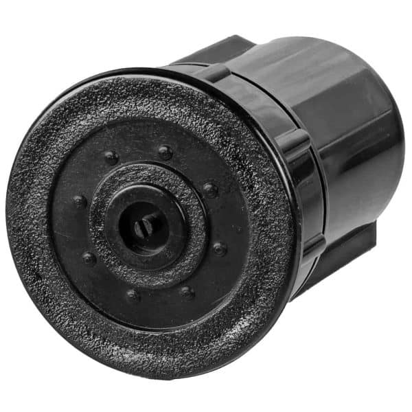 Black textured plastic cap for pepper spray canister, isolated on white background, close-up view.
