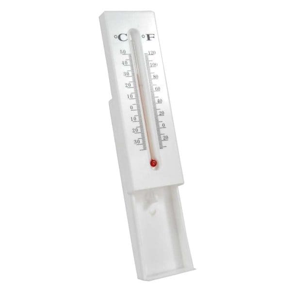 Analog wall thermometer displaying Celsius and Fahrenheit, isolated on white background.
