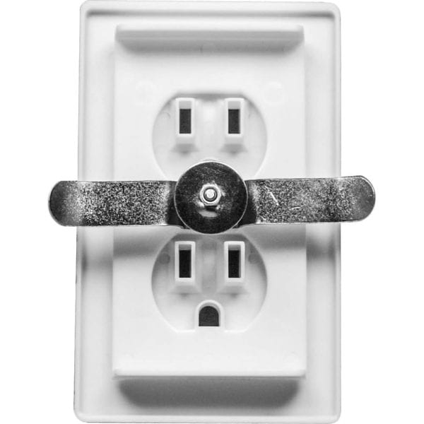 Metal switch cover on a white electrical outlet for child safety and prevention.
