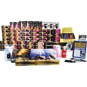 Assorted self-defense products including pepper spray, alarms, and safes displayed in organized rows and stacks.
