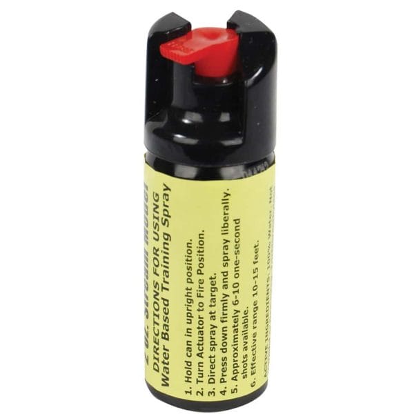Small canister of water-based training spray with a red actuator and yellow label for safety instructions.
