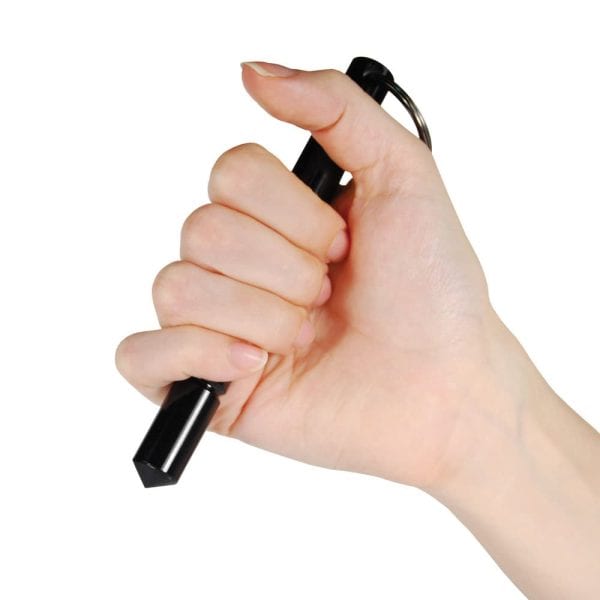 Hand holding a black self-defense kubotan keychain for personal safety.