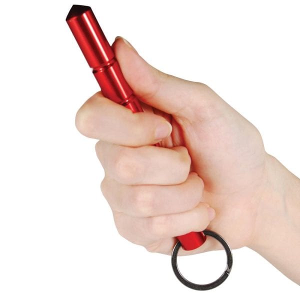 Hand holding a red self-defense keychain tool for personal safety and security.