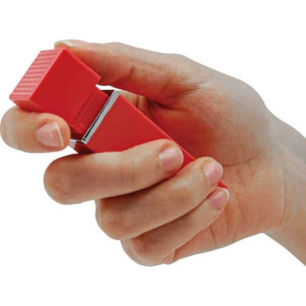 Hand holding a red stress-relief cube, designed for fidgeting and relaxation.