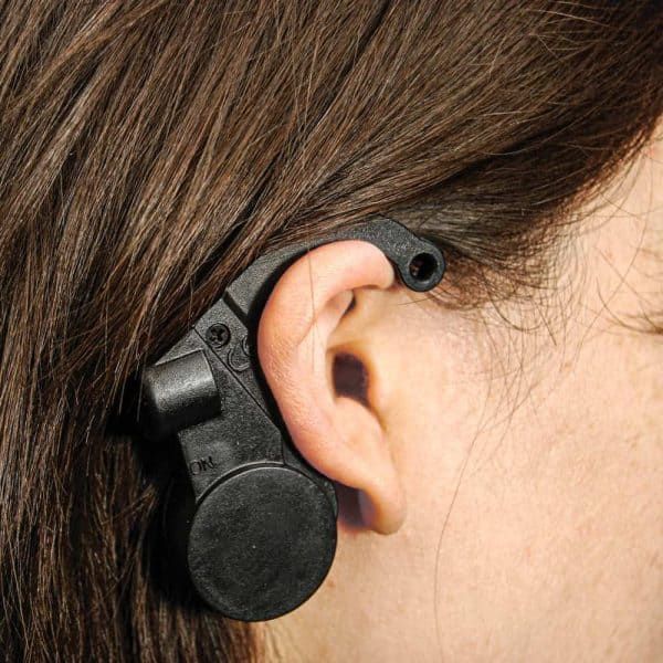 Wearable device hooks over ear, promoting safety awareness for drivers.