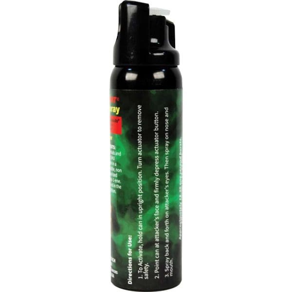 Black pepper spray canister with green label, showing usage instructions on the side.