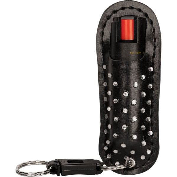 Black pepper spray with studded leather case and keychain for personal safety.