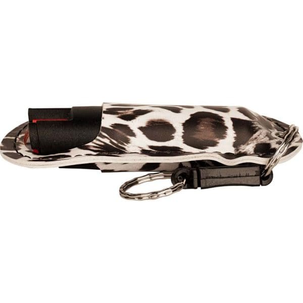 Stylish pepper spray with black and white animal print cover, attached to a keychain for personal safety.