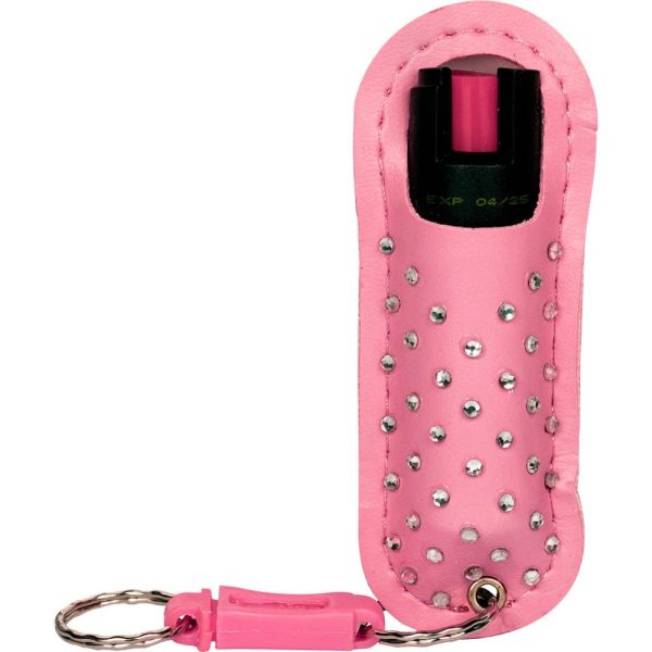 Pink pepper spray with studded case and keychain, personal safety accessory.