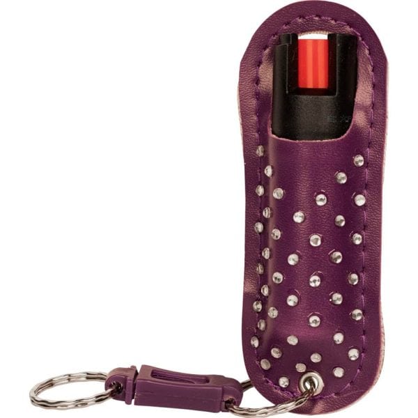 Purple studded pepper spray keychain for self-defense and safety.
