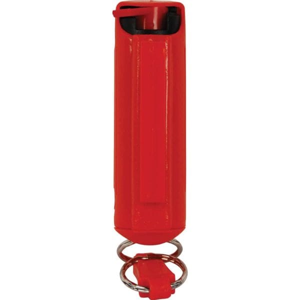Red pepper spray with safety cap and keyring for personal safety and protection.