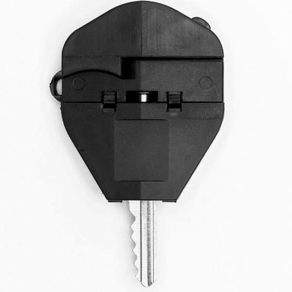 Black car key close-up with a unique blade design against a white background.