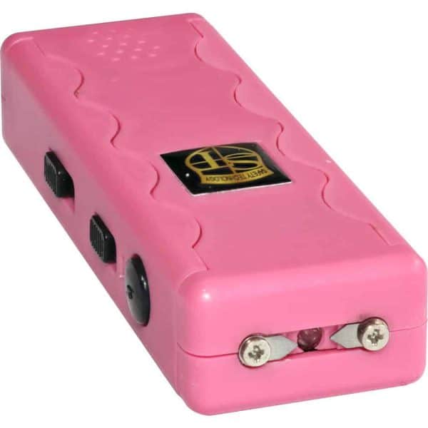 Pink stun gun with a textured grip, featuring a safety switch and charging prongs for personal protection.