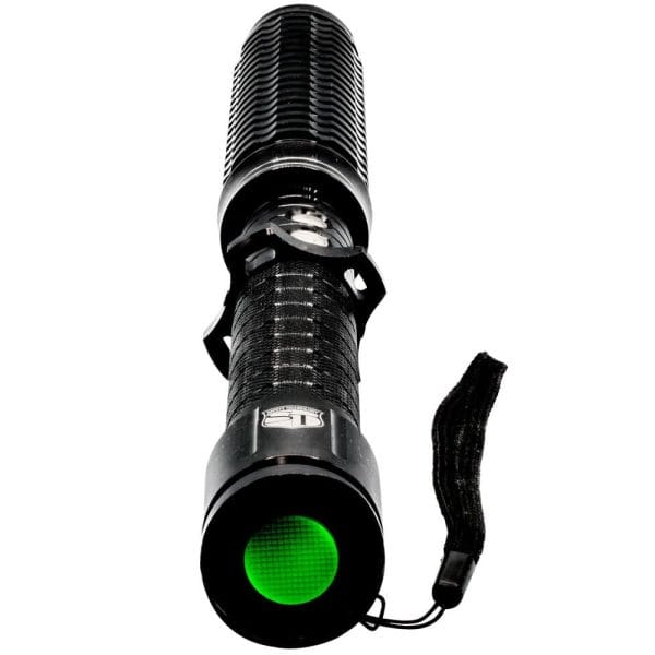 Powerful black tactical flashlight with green button and wrist strap, ideal for outdoor adventures and emergencies.