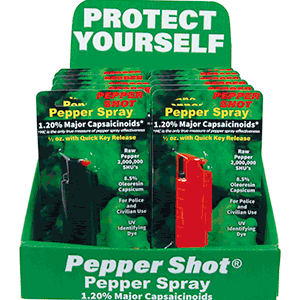 Pepper Shot pepper spray display with green and red canisters labeled 'Protect Yourself' for personal safety.