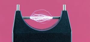 Electric current between two electrodes against pink background.