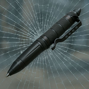 Tactical pen on cracked glass background, showcasing durability and multi-functionality.