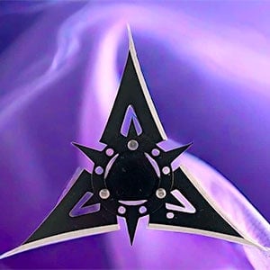 Black ninja star with sharp, triangular blades against a vibrant purple background.